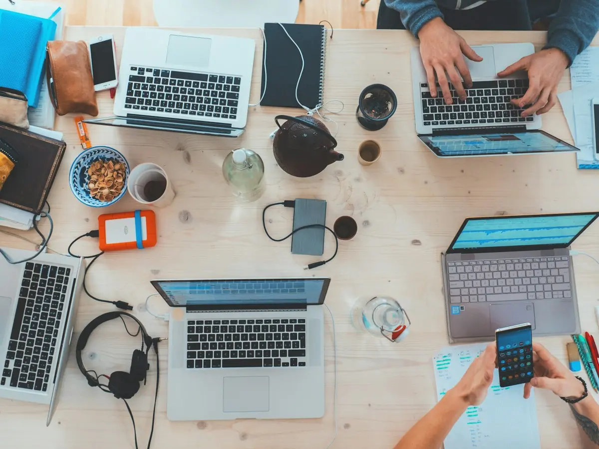 Colleagues sharing a workspace and collaborating with computers
